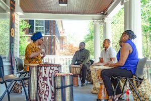 Group gathering on a covered porch for casual outdoor meeting or discussion.