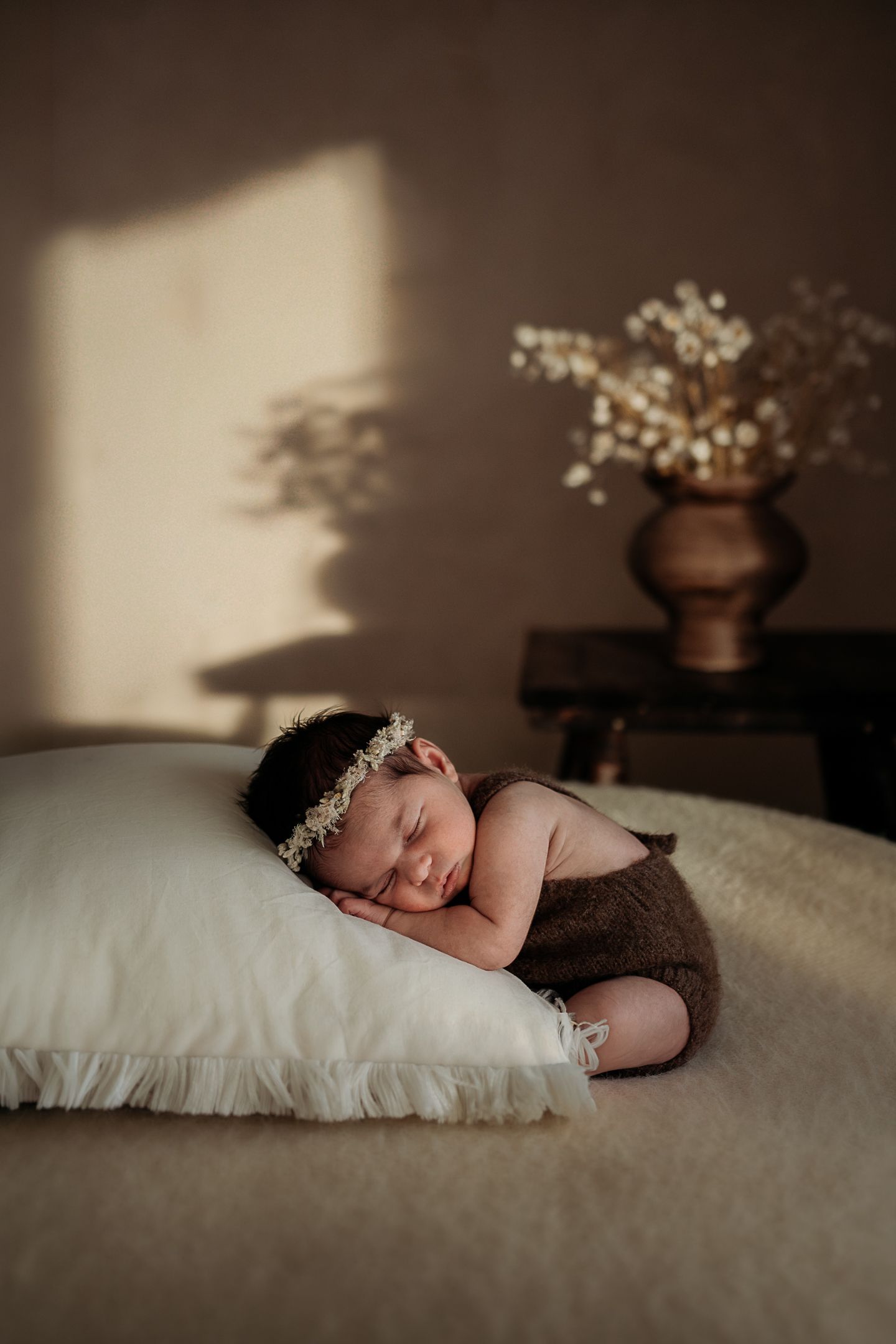 Newborn resting on pillow in Penrith newborn studio