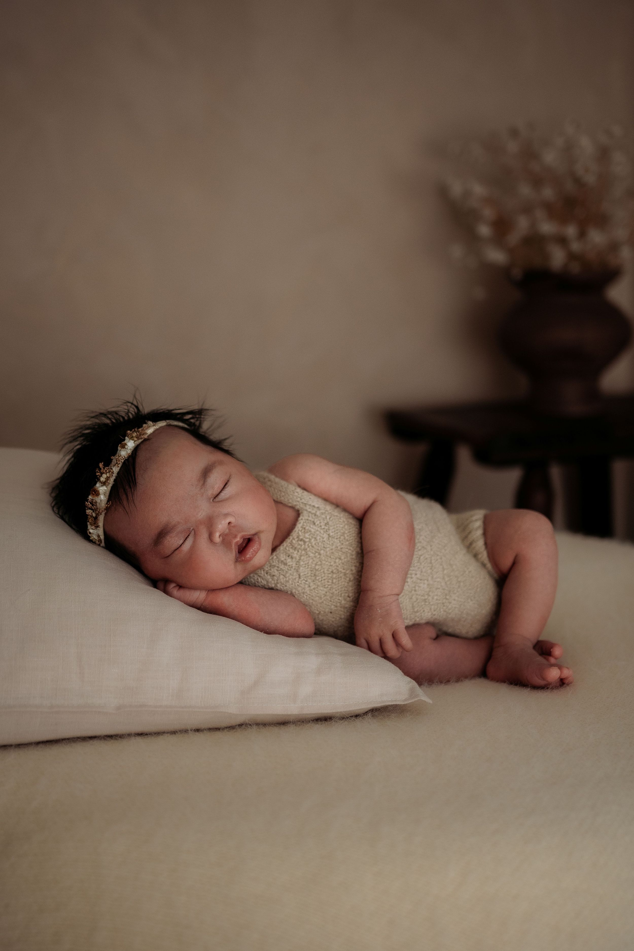 Newborn resting on pillow in Penrith newborn studio