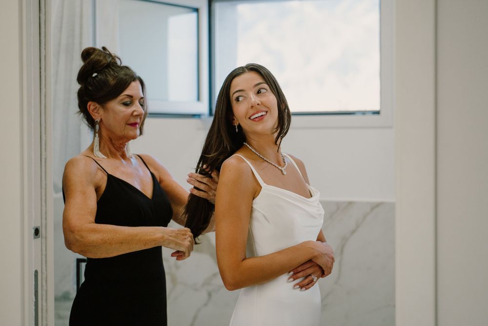 Bride getting ready with her mom for her destination wedding in Sicily