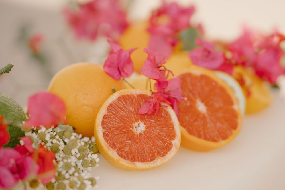 Wedding table decor in Sicilian style with oranges and bougainvillea flowers