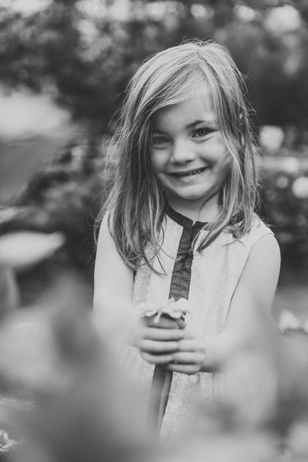 A series of black and white portraits showing a child joyfully eating ice cream on a summer day.