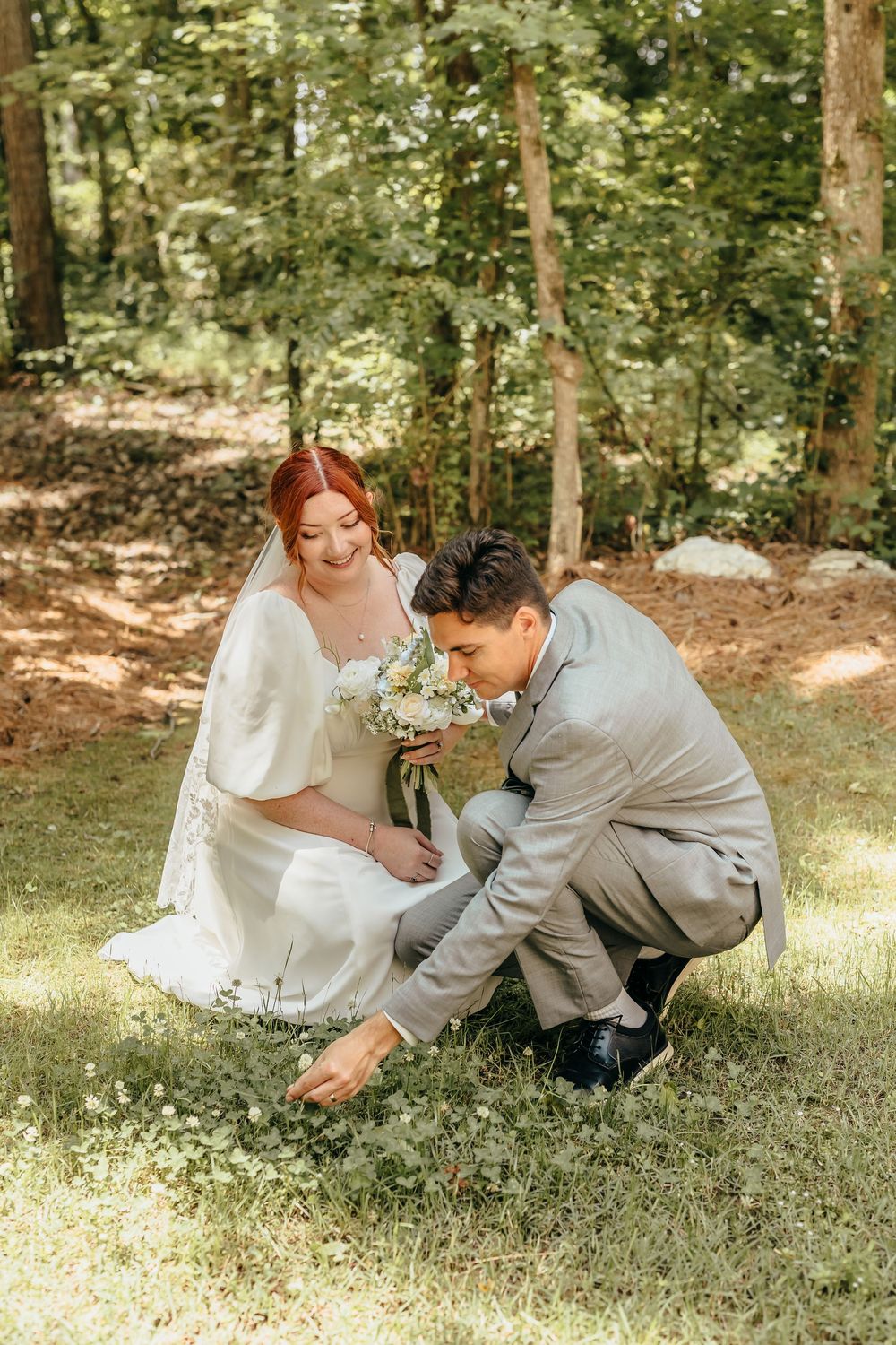 Joyful wedding couple sharing laughter in a sunlit forest setting. North Carolina Chapel. Birdsong Chapel at The Cornealius Properties.