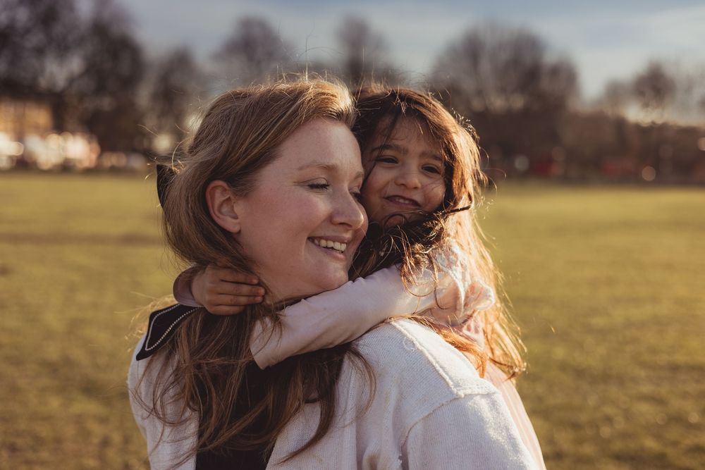 girl hugs mum on her back