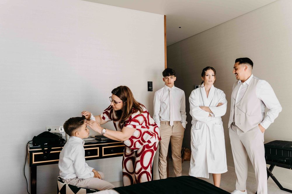 A group getting ready in a modern minimalist room wearing light colored clothing.
