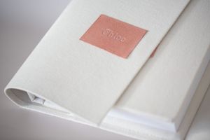 A series of images showing white folded fabric with soft pink lighting against a neutral background.