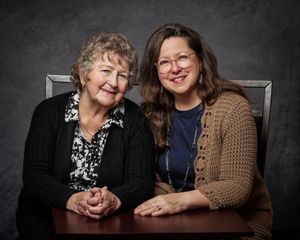 A series of black and white professional studio portraits showing candid moments between two women posing together.