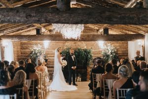 Wedding ceremony setup in a rustic barn venue with wooden beams at Grand Lodge Oaklands - taken by Grimsby photographer.