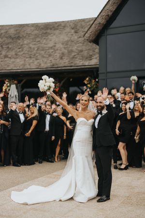 Wedding celebration showing party guests in formal attire raising their hands outside Grand Lodge Oaklands - taken by Grimsby photographer.