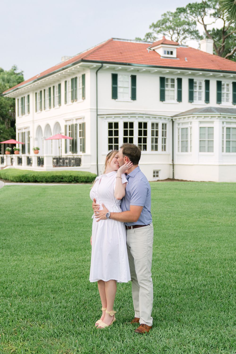 Bride-to-be smiling during surprise engagement at Cherokee Cottage, Jekyll Island Historic District.
