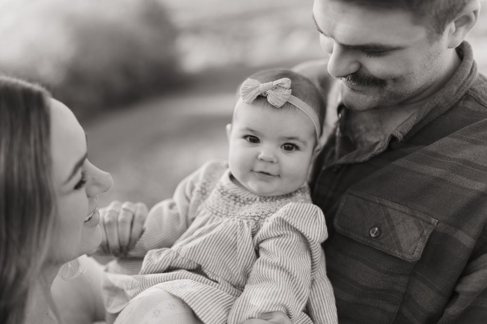 Black and white intimate portrait of a family sharing a sweet moment together.