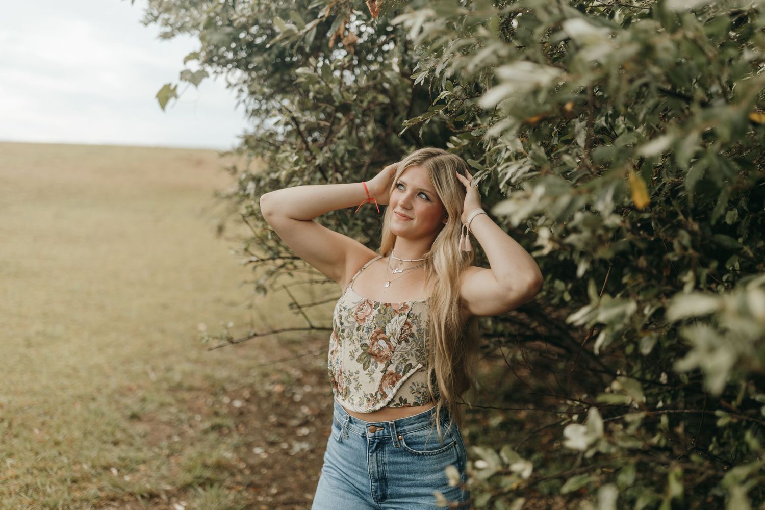 Casual outdoor portrait in a sun-lit field with natural styling. Virginia graduation/senior session.