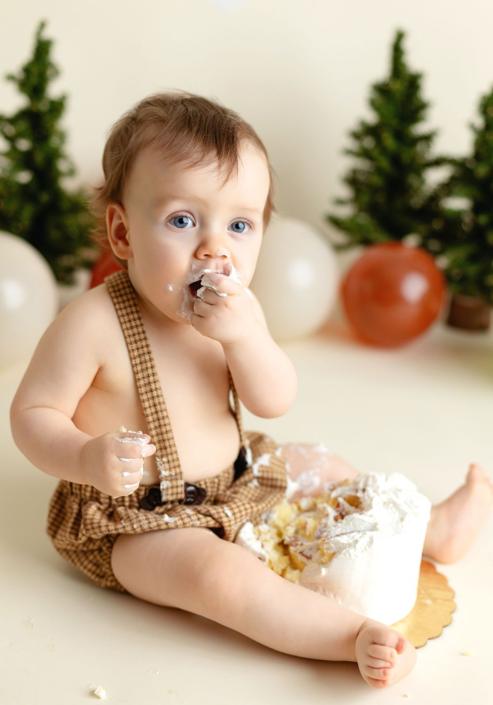 A one-year-old eating cake for his smash-the-cake session. Greenville SC newborn photographer, Easley Sc photographer