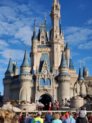 Multiple views of the iconic Cinderella Castle at Disney World's Magic Kingdom against a bright blue sky.