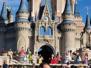 Cinderella Castle at Walt Disney World's Magic Kingdom stands majestic against a bright blue sky.