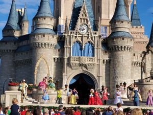 Colorful stage performance taking place in front of Cinderella Castle at Walt Disney World's Magic Kingdom.
