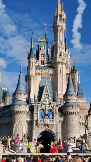 Characters perform on stage in front of Cinderella Castle during a show at Walt Disney World's Magic Kingdom.
