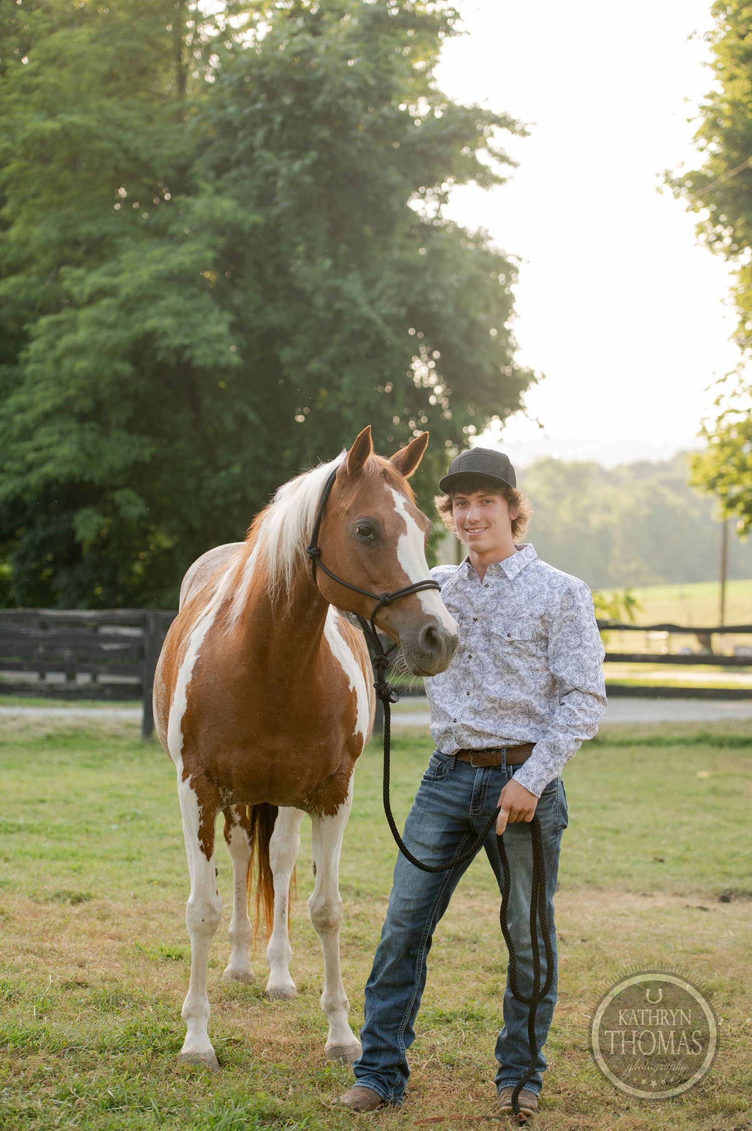 Paint horse with distinctive markings stands beside companion in rustic farm setting.