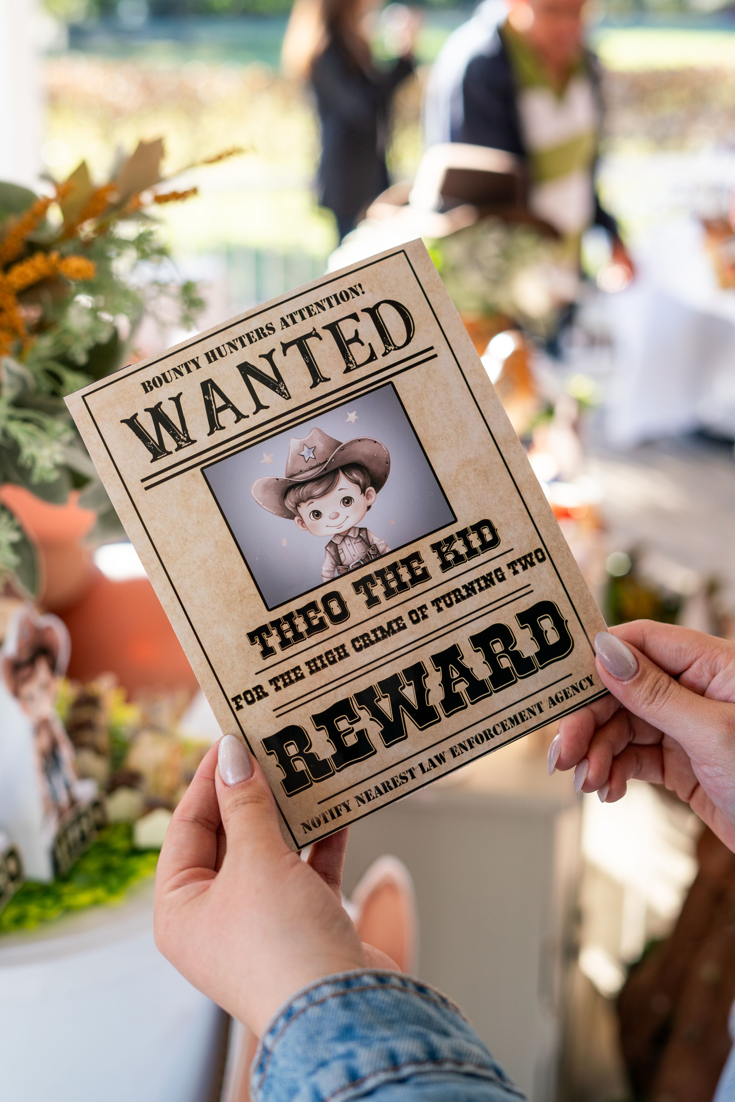 Old west style 'WANTED' posters displayed at a themed party.