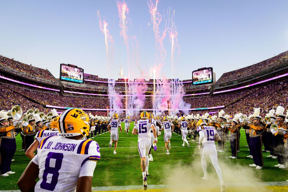 Pink fireworks display at LSU football stadium during night game celebration.