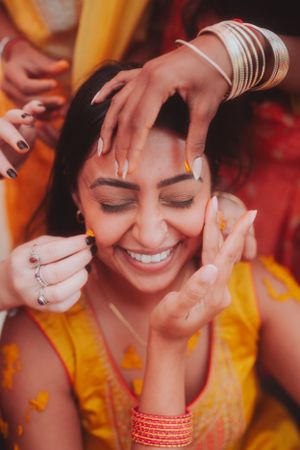 Joyful celebration moment with traditional Indian wedding preparations.