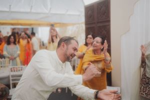 People celebrate with laughter and dancing at a festive indoor gathering.