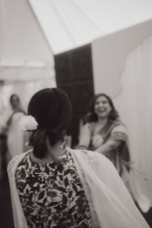 People celebrating at a wedding reception in traditional Indian attire.