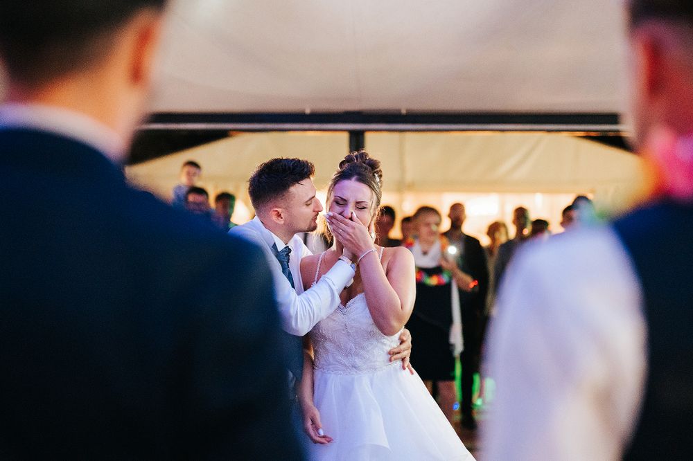 Bride and groom sharing a joyful moment together on the dance floor at their wedding reception.