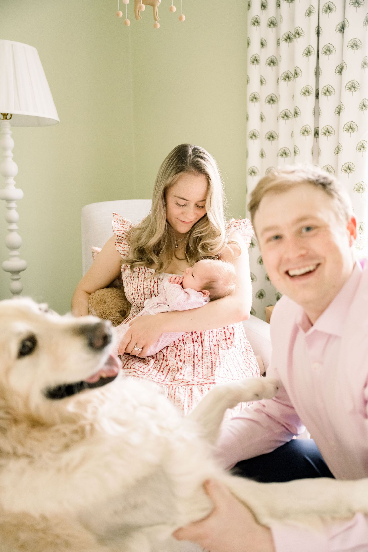 Tender moment between new parents and their sleeping newborn baby.