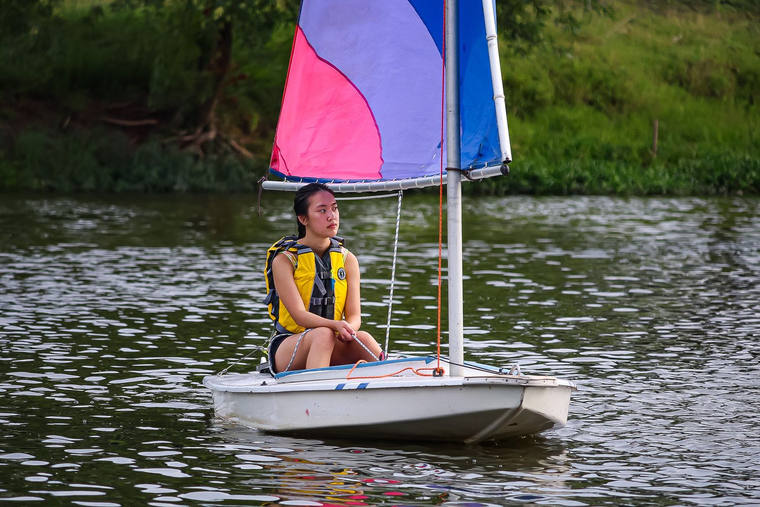 Female College Student steering a sailboat