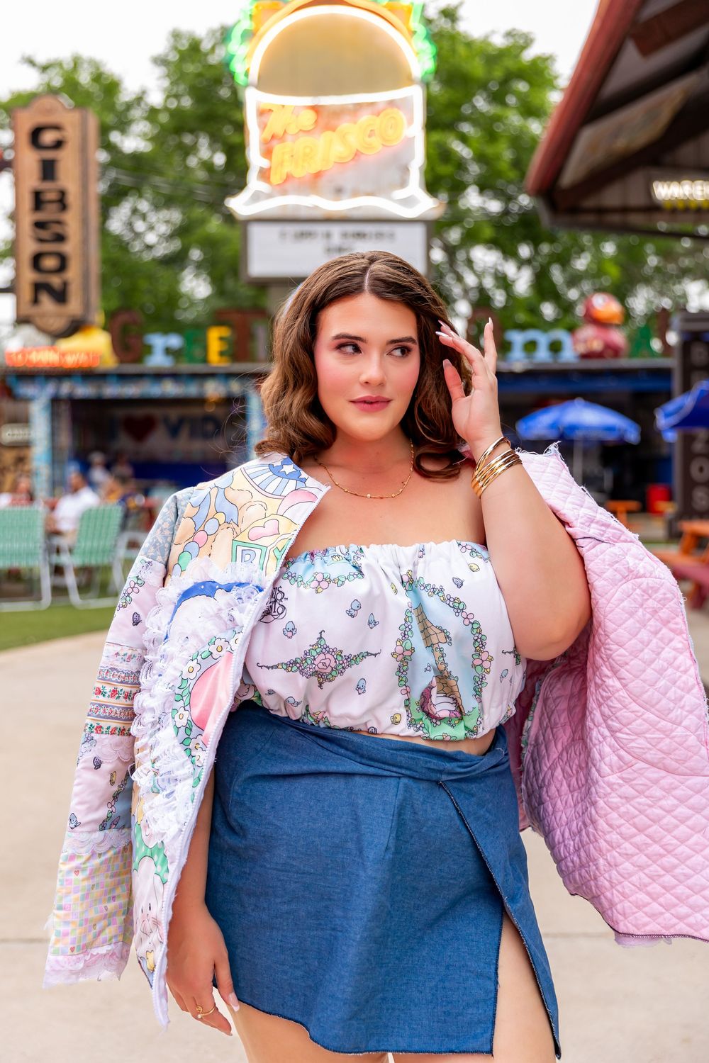 A woman in denim and floral clothing poses for a series of fashion photos at a fairground or outdoor event.