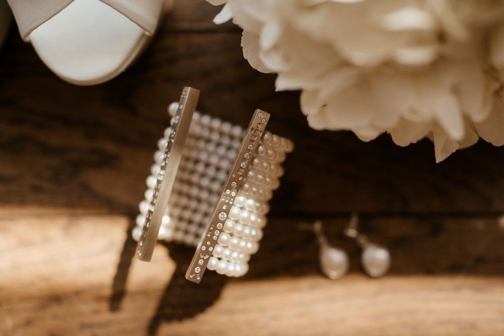 Artistic close-up of crystal wedding jewelry accessories in warm lighting.