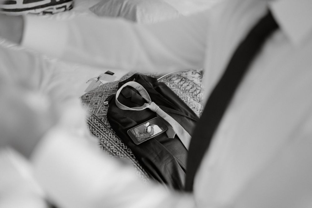 Black car key with ring resting on gray fabric in black and white photography.