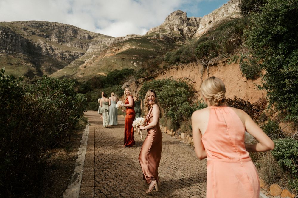 Guests walking along a scenic mountain path during a destination wedding ceremony.