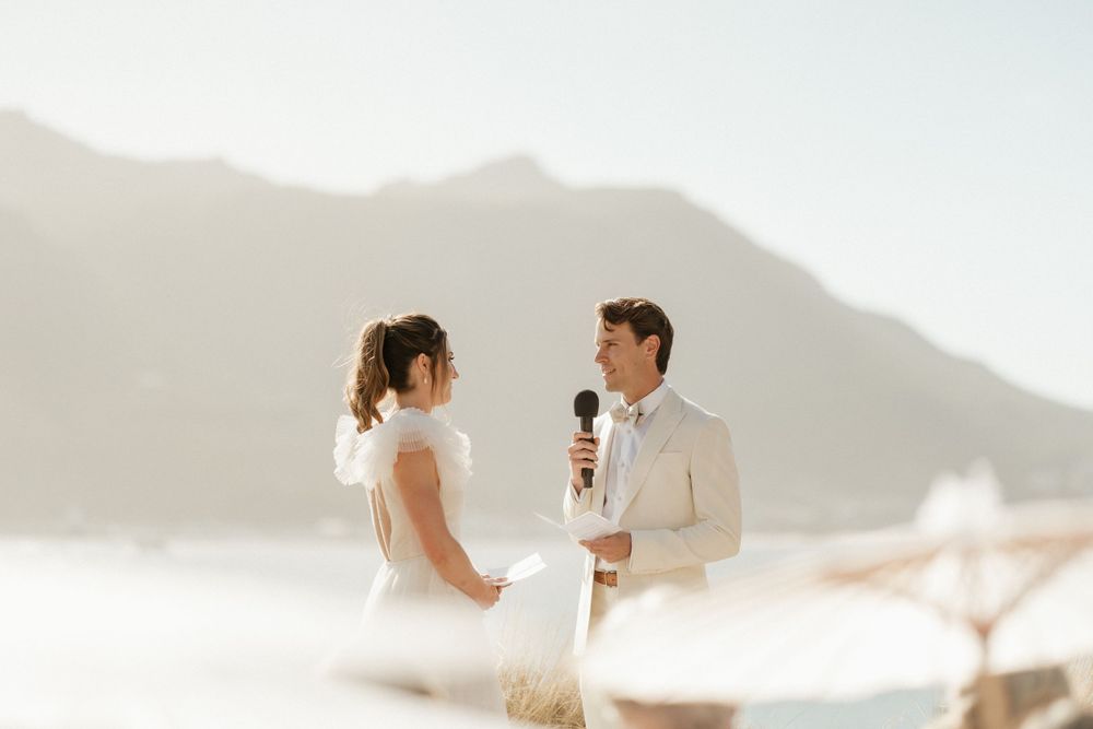 Couple shares an intimate moment against a misty mountain backdrop during their ceremony.