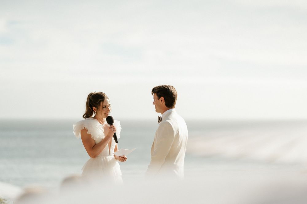 Intimate beachside wedding ceremony with ocean views and soft lighting.