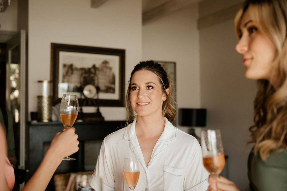 Gathering of people in a room toasting with champagne glasses.