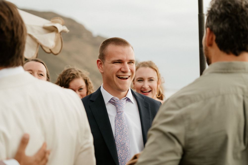 Joyful moment shared between wedding guests during an outdoor celebration.