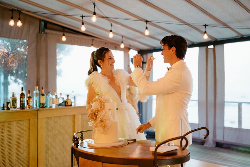 Wedding celebration moment with couples toasting at illuminated indoor bar.