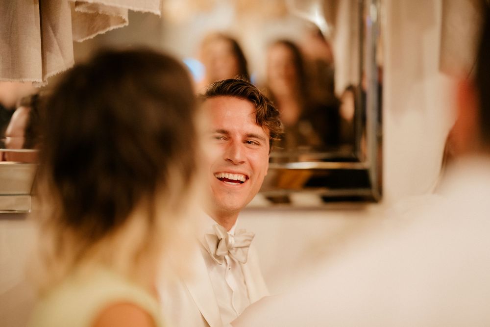 A candid moment of joyful laughter during a wedding celebration.