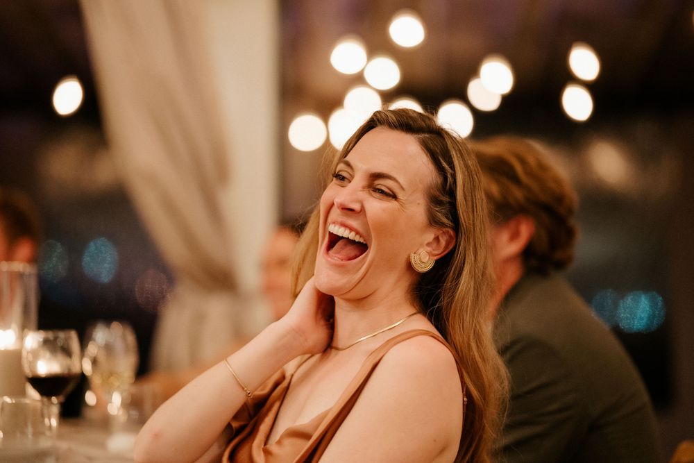 Candid moment of joy during an intimate evening wedding reception.
