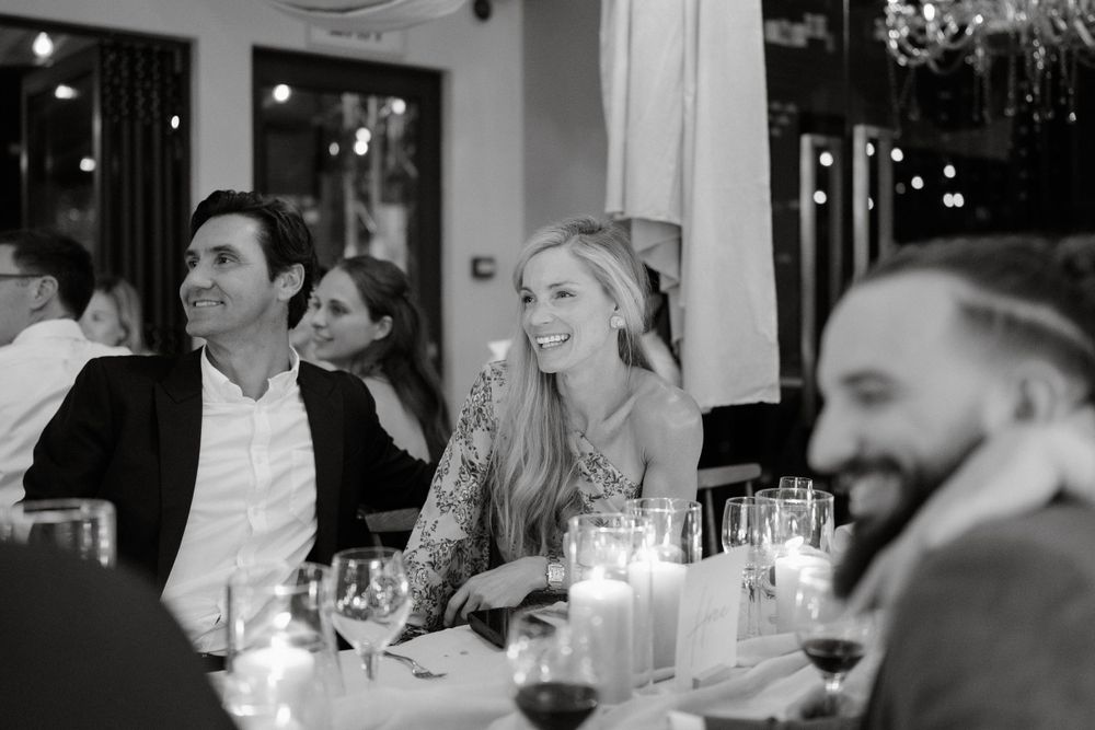 Guests enjoying an evening reception with candlelit table settings.