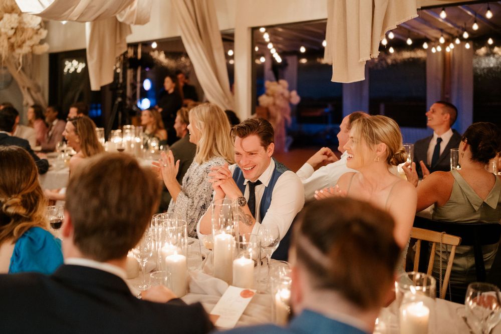 Candlelit wedding reception dinner with guests enjoying evening celebrations.