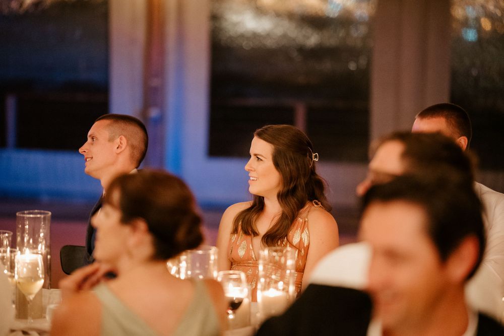 Candlelit reception dinner featuring elegant table settings and soft ambient lighting.