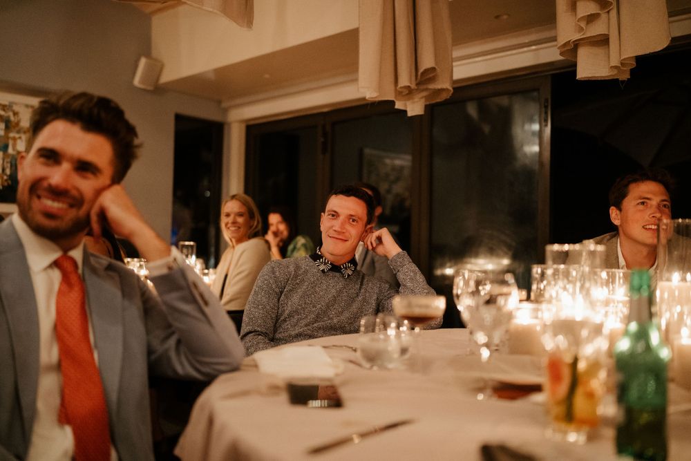 Candlelit wedding reception with guests enjoying evening conversations.