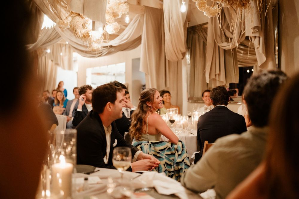 Elegant wedding reception with white drapes and candlelight creating a romantic atmosphere.
