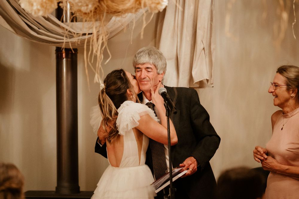 An emotional dance moment between the bride and a guest during wedding reception celebrations.