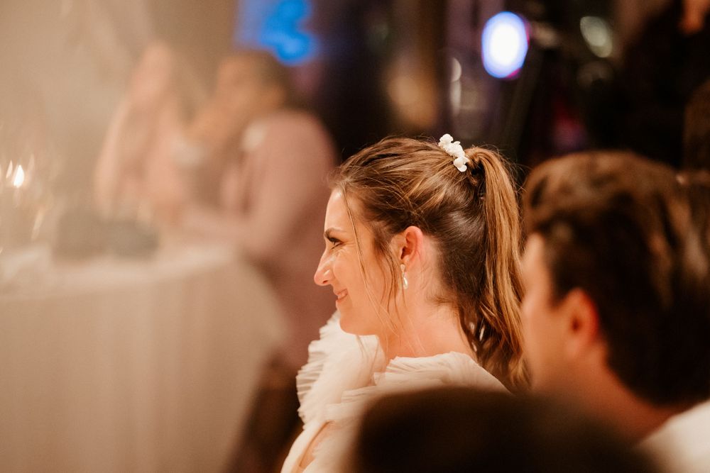 Side profile of wedding guests during an evening reception celebration.