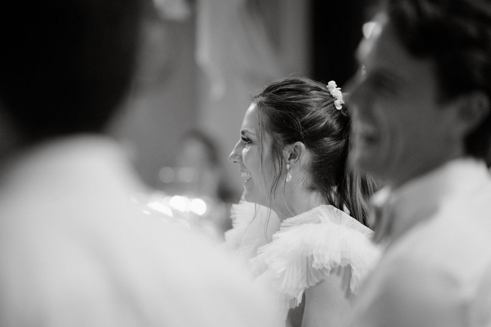 Side profile wedding reception shot with soft focus and elegant details.