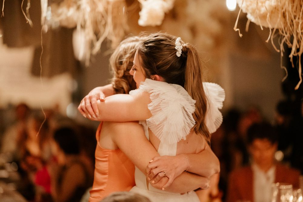 Romantic sepia-toned dance moment at a wedding reception.